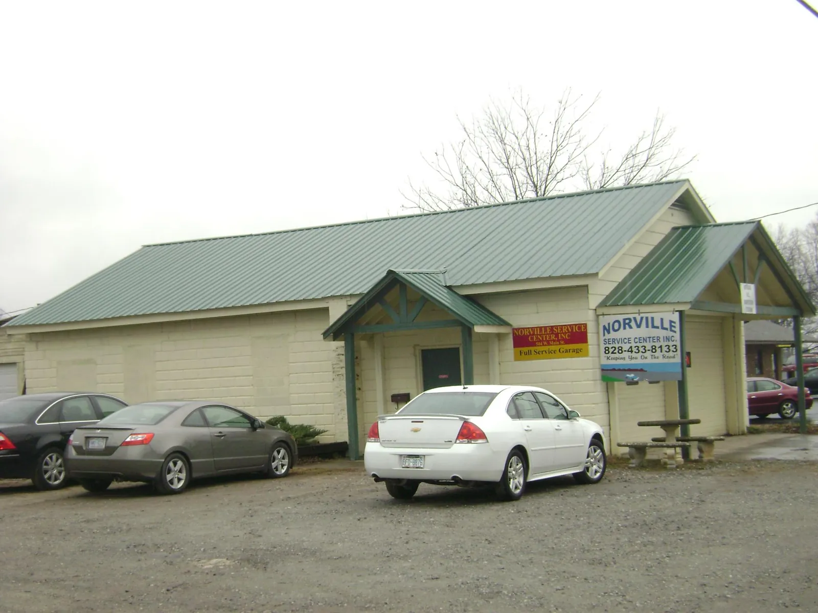Green metal roof on a service garage with a covered entry in Pembroke